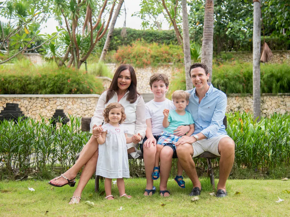 Parents and children sitting together in a tropical garden